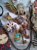 Close up of an "ita bag," a bag full of fandom pins and chotchkis. This one has mostly Hard Rock Cafe pins and FFVII keychains.